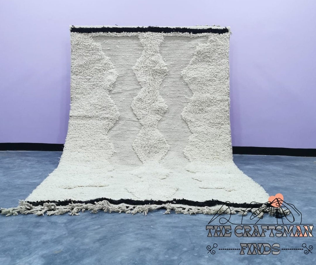 Authentic Beni Ourain rug with classic black diamond pattern on cream wool
