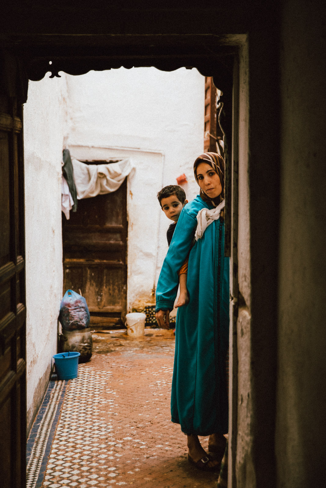 A tourist navigating the narrow, colorful labyrinthine streets of a Moroccan medina