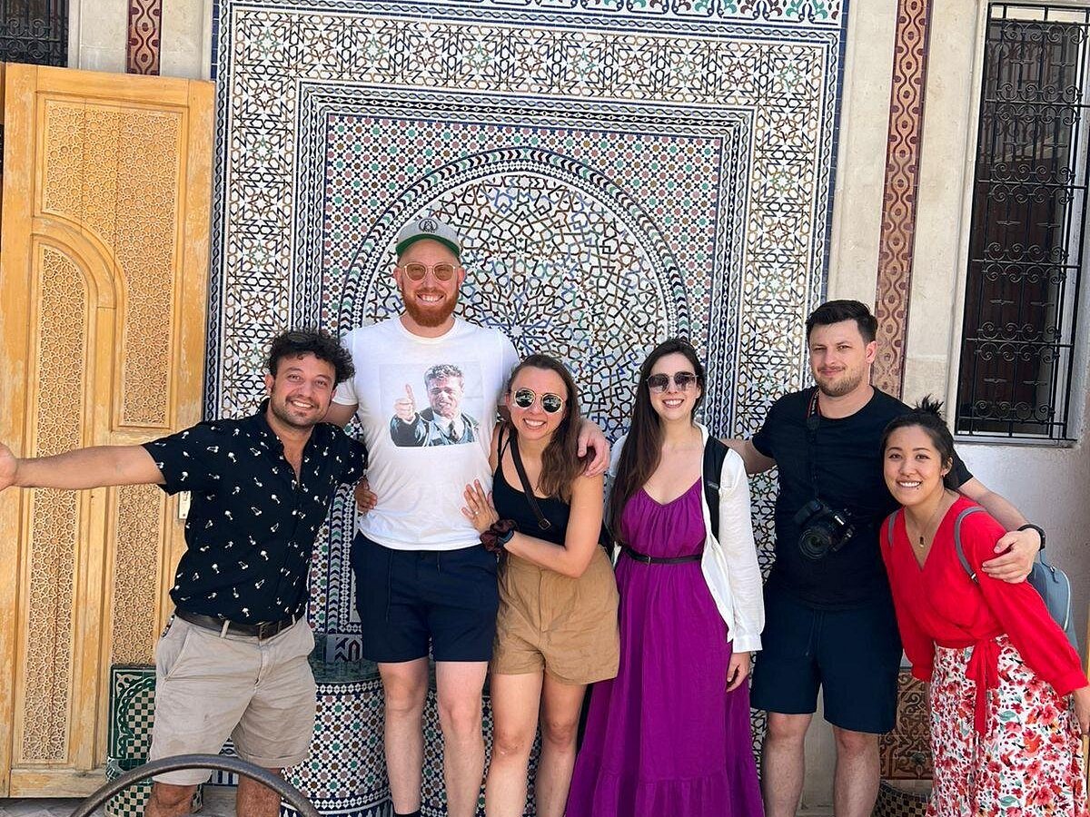 Waj from Morocco Arukikata posing with a female guest at a beautiful Moroccan landmark